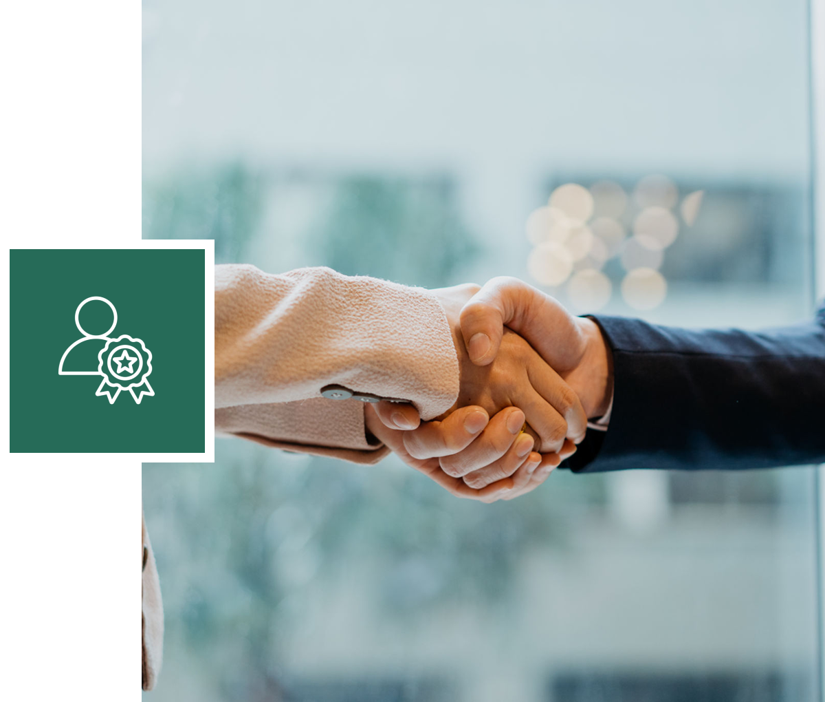 Handshake with certification icon overlay.